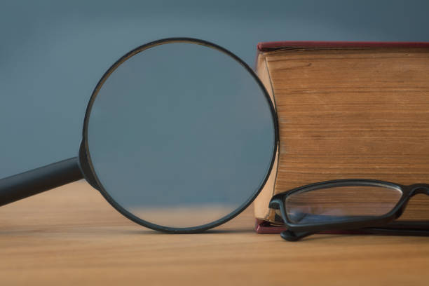 Book and magnifying glass,Research Concept