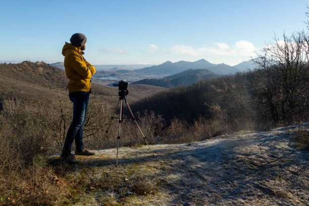 photographer in jaket shoot landscape at early fall